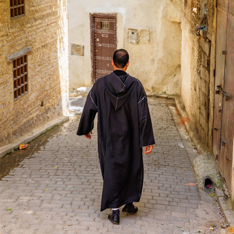 Maroccan man walking in Medina of Fes, Morocco